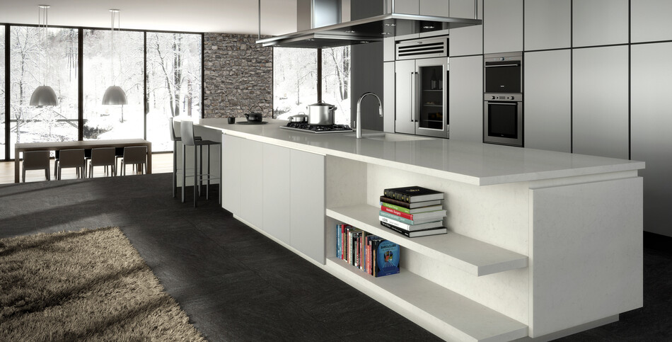 A kitchen island with built-in bookshelves of London Grey quartz, an eloquent, opaque, light-gray traversed with soft charcoal veins.