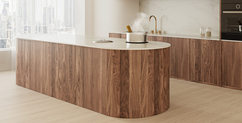 A hot pot sits atop a kitchen island of white Snowdrift porcelain with golden-brown veining.