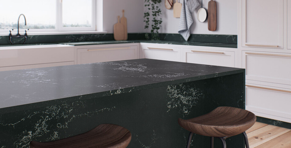 A kitchen countertop and island of Empira Black, a dark quartz with fine white veining.