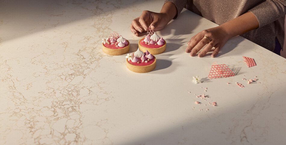 Tarts sit on a countertop of white Goldfinch quartz with burnt amber veining.