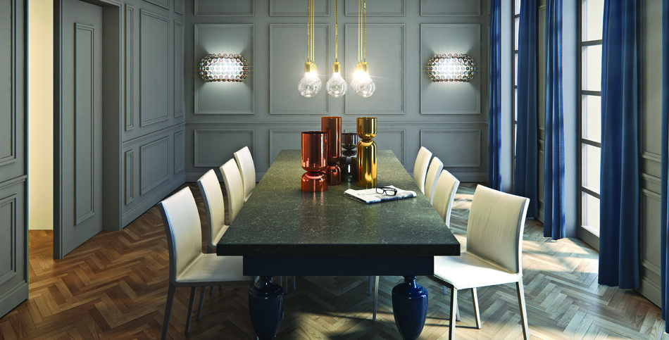 A dining room table of smooth slate with chalky white veins in a marble design.