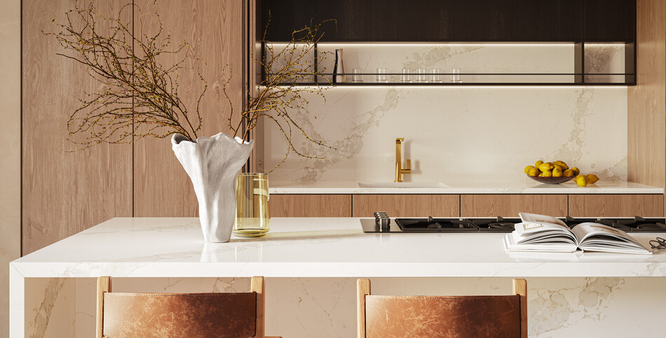 Kitchen island with a waterfall edge in Calacatta Nectar quartz of white with golden veins and bands of light grays in front of matching backsplash.