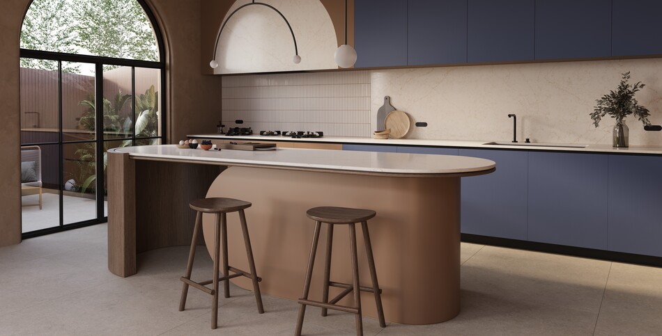 Modern kitchen featuring fluid curves of the Rossa Nova Caesarstone ICON island, warm beige walls, and black-framed glass doors.