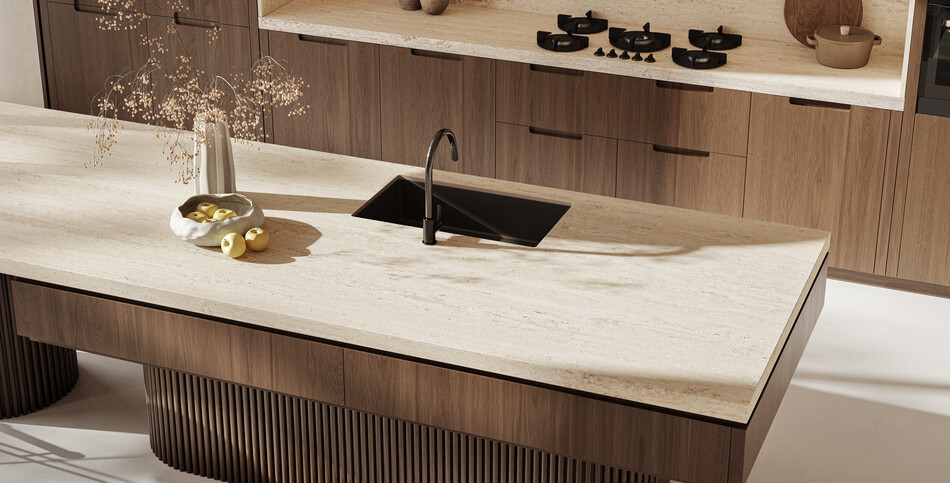 Luxury kitchen with dark wood veneer, travertine-look Travina porcelain, and fluted island detail.
