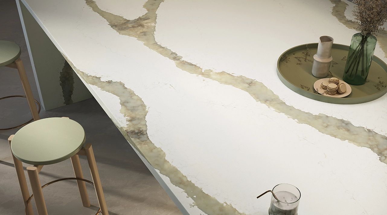 Close-up of the dramatic, thick gray and gold veining and warm white base of the Caesarstone ICON advanced fusion surface in Calacatta Thyme.